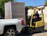 Picking up a crate full of food to be distributed by Adventist Health to local agencies, churches and more.